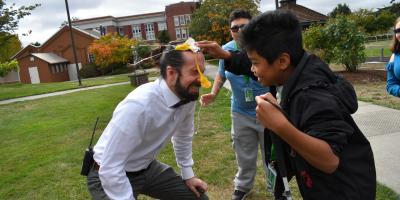 Mr. McCormick getting an egg smashed on his head by a middle schooler with yolk and shell oozing down the front of his face